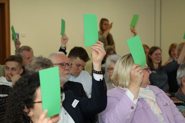 Publikum heben grüne Kärtchen hoch